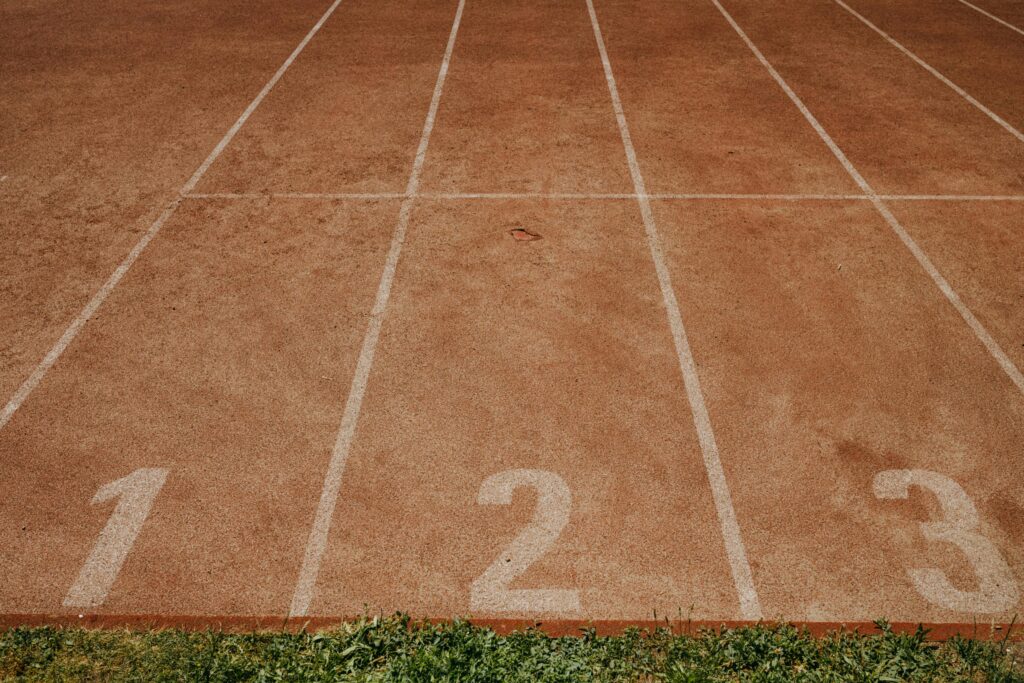 Outdoor sports track with lanes numbered 1 to 3, ready for an athletic event.